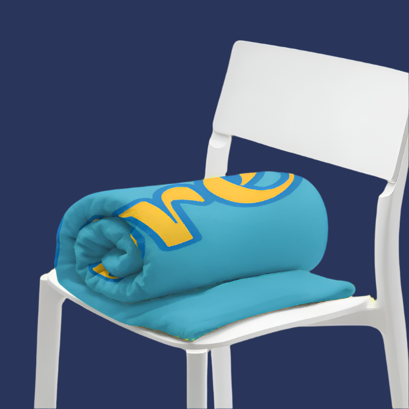 Turquoise blanket with yellow text on a white chair against a white background