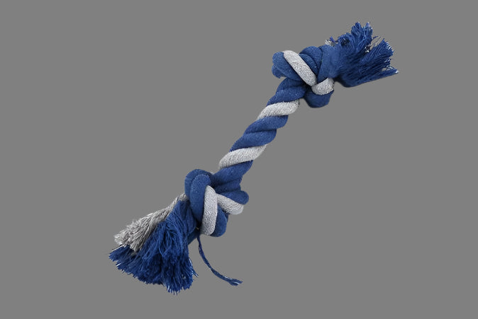 Blue and gray braided rope toy on a white surface with a blurred background