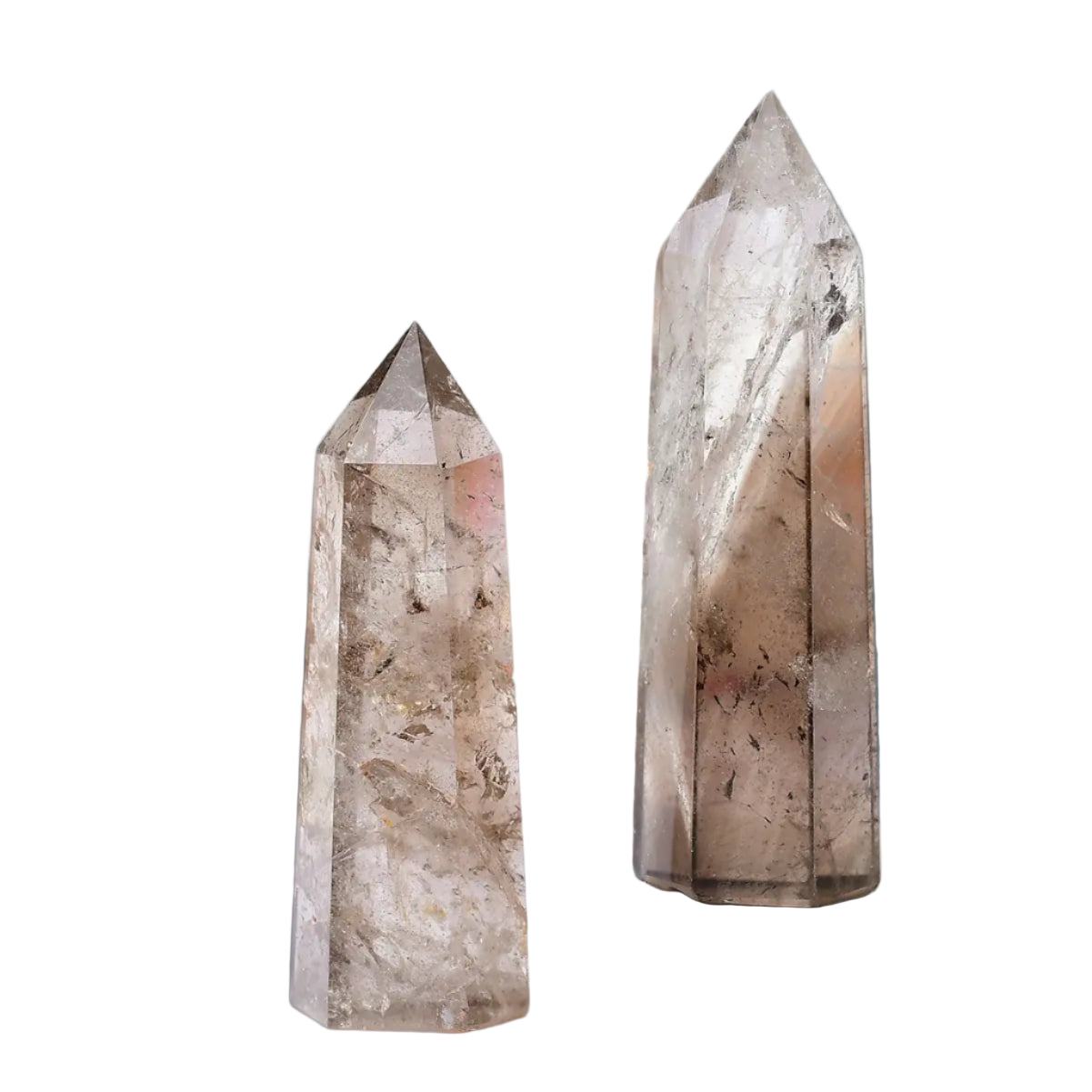 Two crystal towers on a white surface with a blurred background
