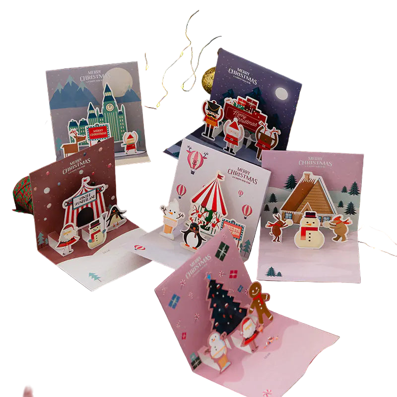 Collection of Christmas-themed pop-up cards on a festive background with lights and decorations.