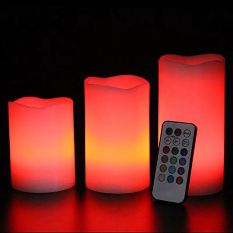 Set of three LED candles with a remote control on a black background