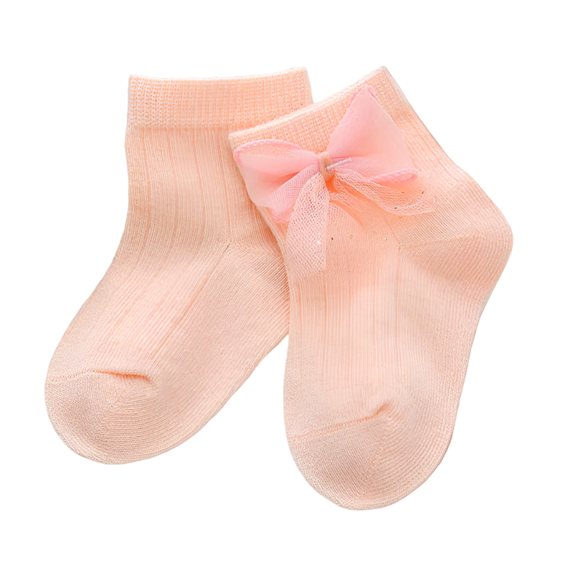 Pair of peach-colored socks with a bow on a light background