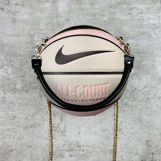 Nike basketball-shaped bag with chain strap on a concrete background