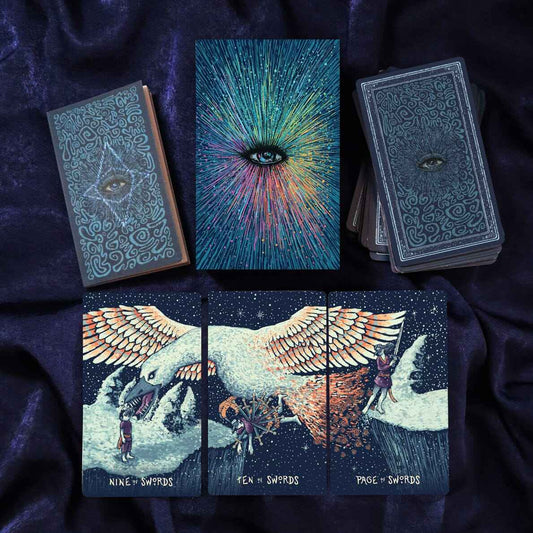 Collection of tarot cards with artistic designs on a dark fabric background