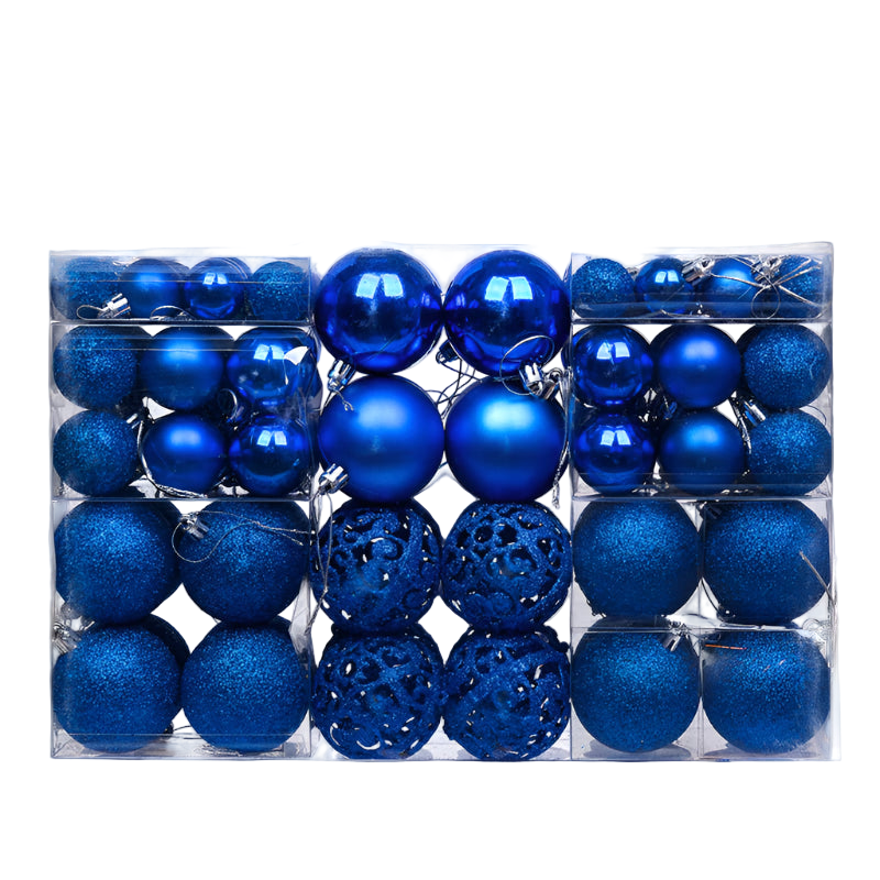 Assorted blue Christmas ornaments in a clear packaging box on a white background