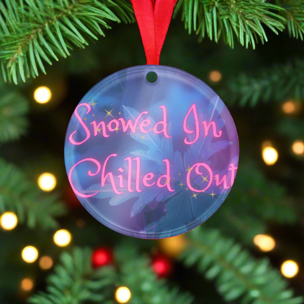 Round decorative item with 'Snowed In Chilled Out' text on a blue background