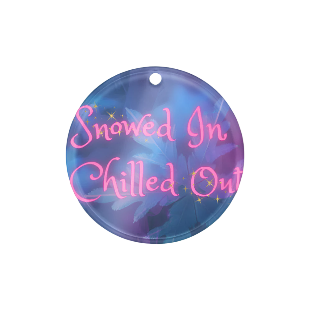 Round decorative item with 'Snowed In Chilled Out' text on a blue background