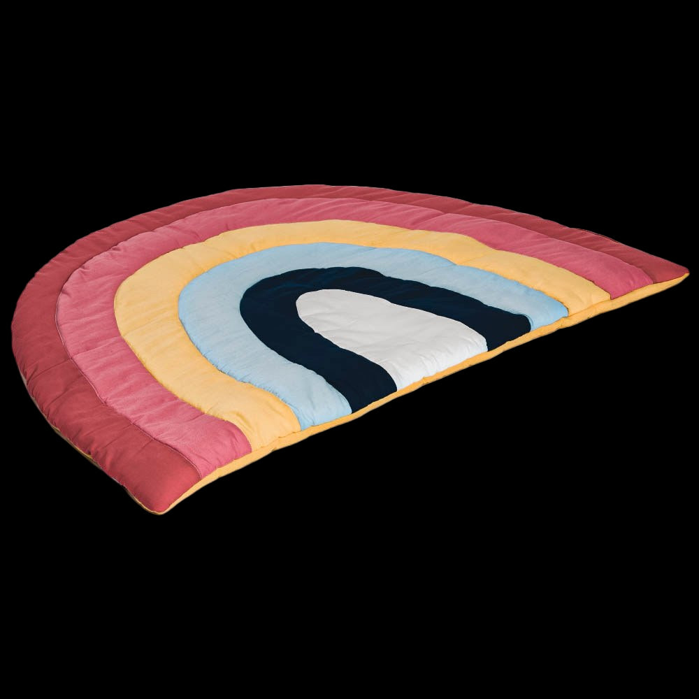 Rainbow-shaped quilt with colorful layers on a white background