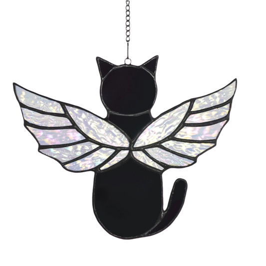 Black cat-shaped ornament with iridescent wings on a white background