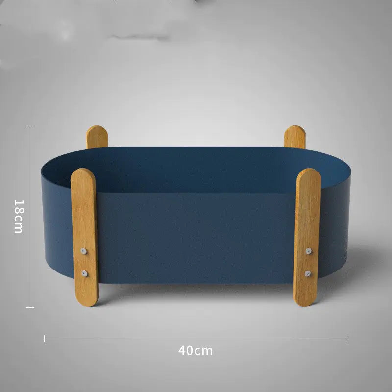 Blue pet bed with wooden sides on a gray background