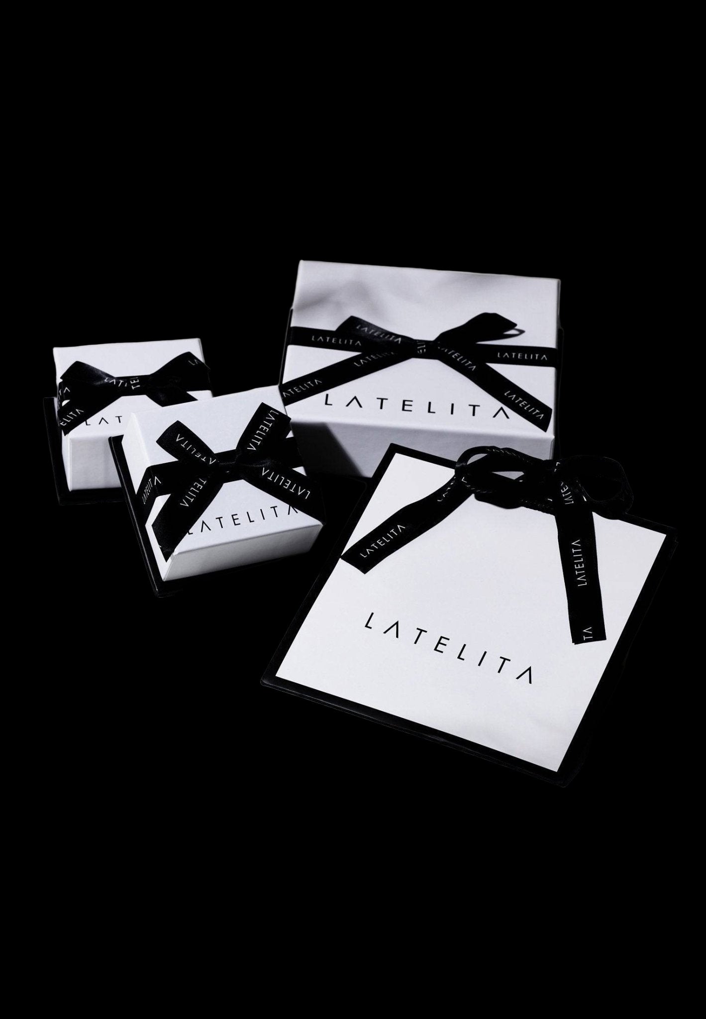 LATELITA boxes with black ribbons on a light background