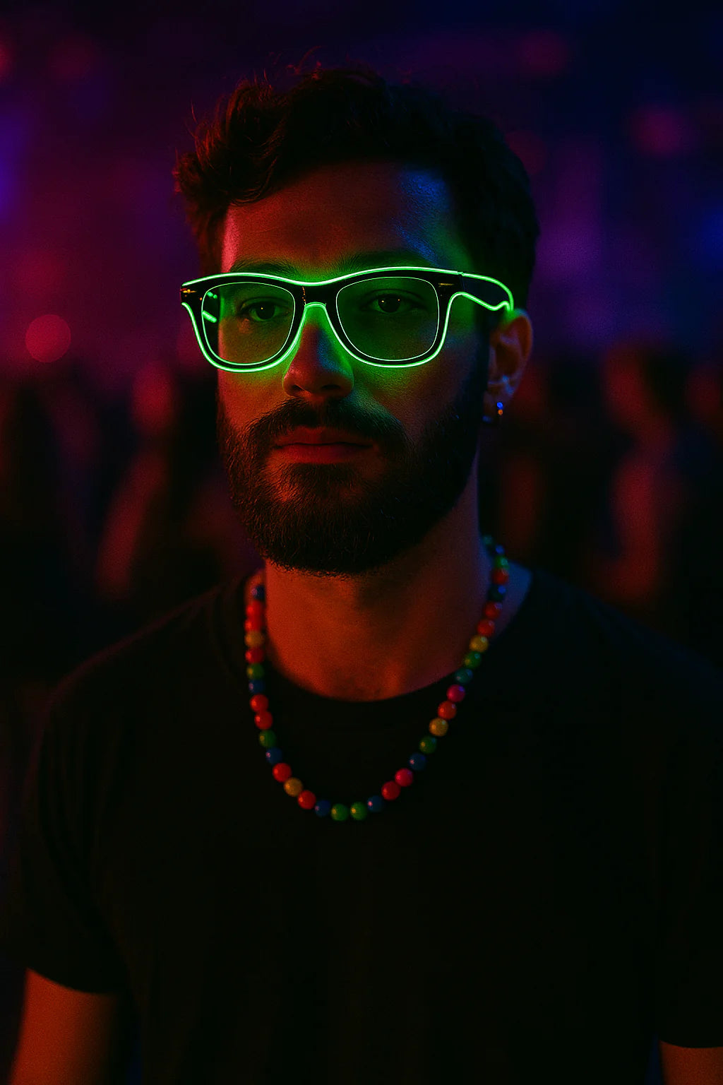 Man wearing neon green glasses in a dark setting with colorful lights