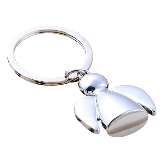 Silver bell-shaped keychain on a wooden surface