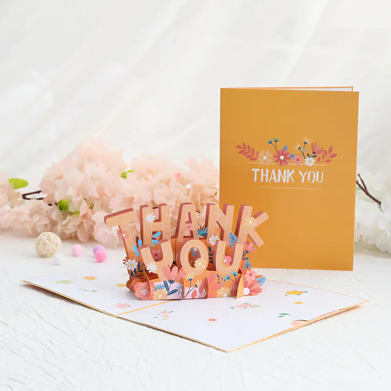 Pop-up card with 'Thank You' text and floral decorations on a white background