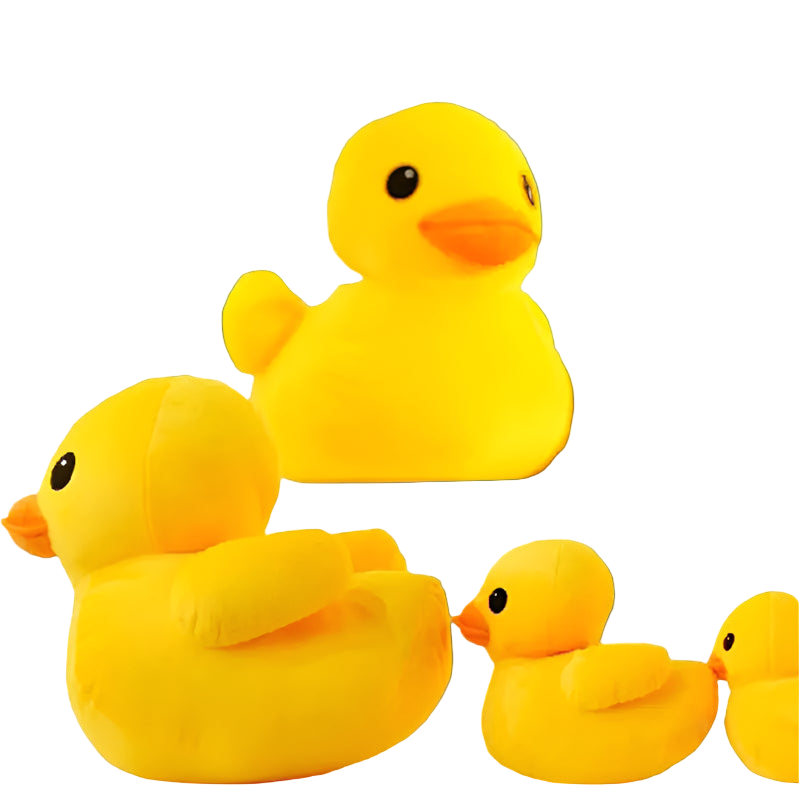 Four yellow rubber duck plush toys on a light wooden surface with a brick wall background.
