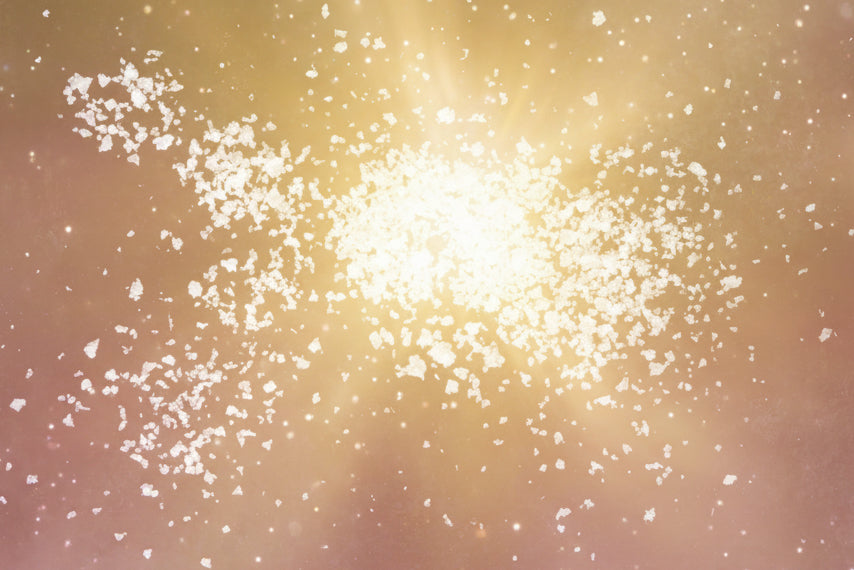 White salt crystals on a dark textured surface