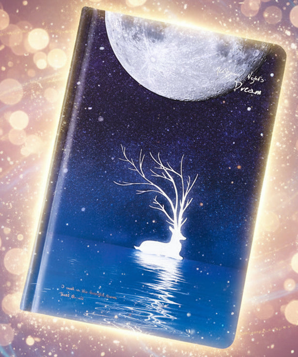 Notebook with a moon and tree design on a dark background