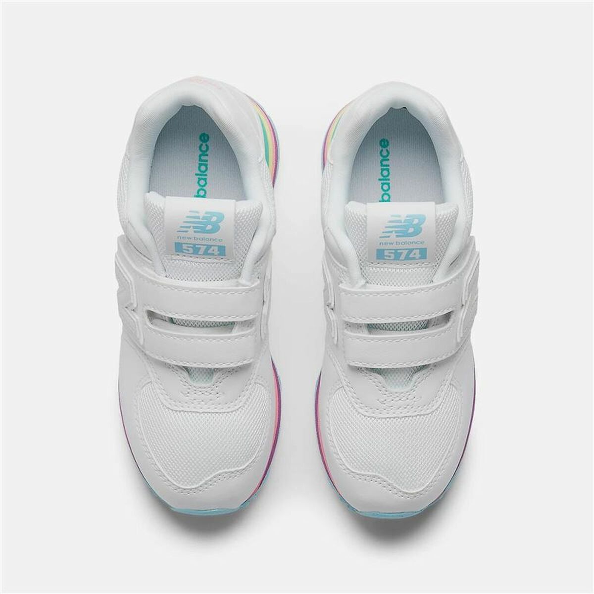 White sneakers with velcro straps on a light gray background