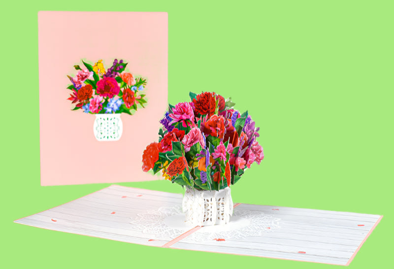 Colorful bouquet of flowers in a vase with a matching card on a white background
