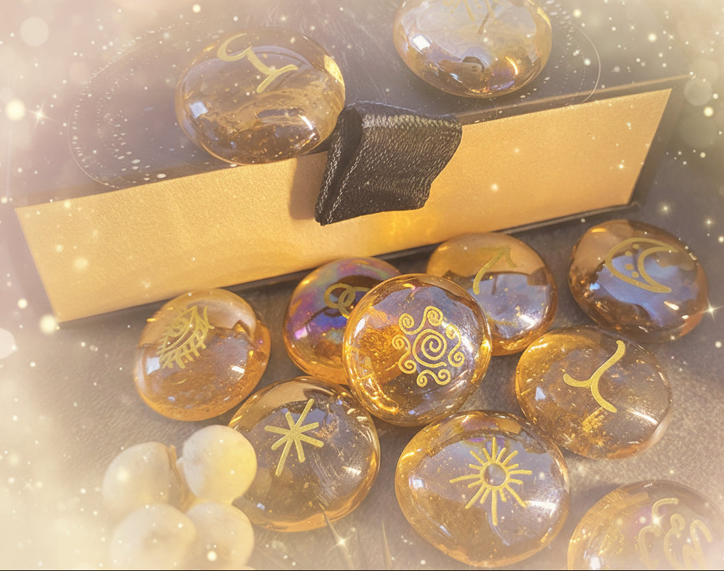 Transparent stones with engraved symbols on a dark surface