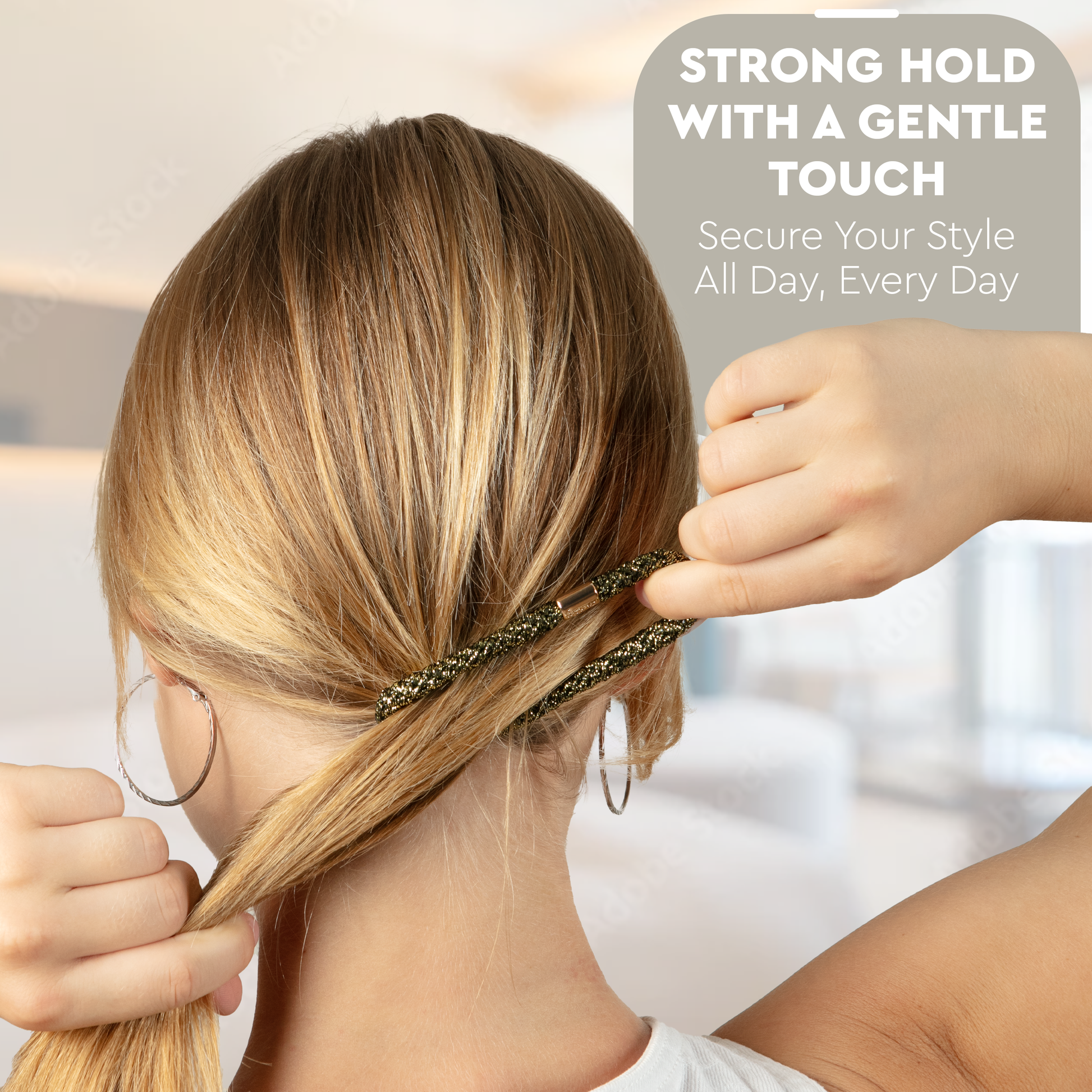 Person styling hair with a hair tie, text 'Strong hold with a gentle touch' on a blurred background