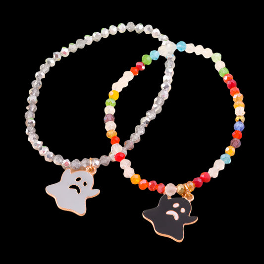 Colorful beaded bracelet with ghost charms on a beige background