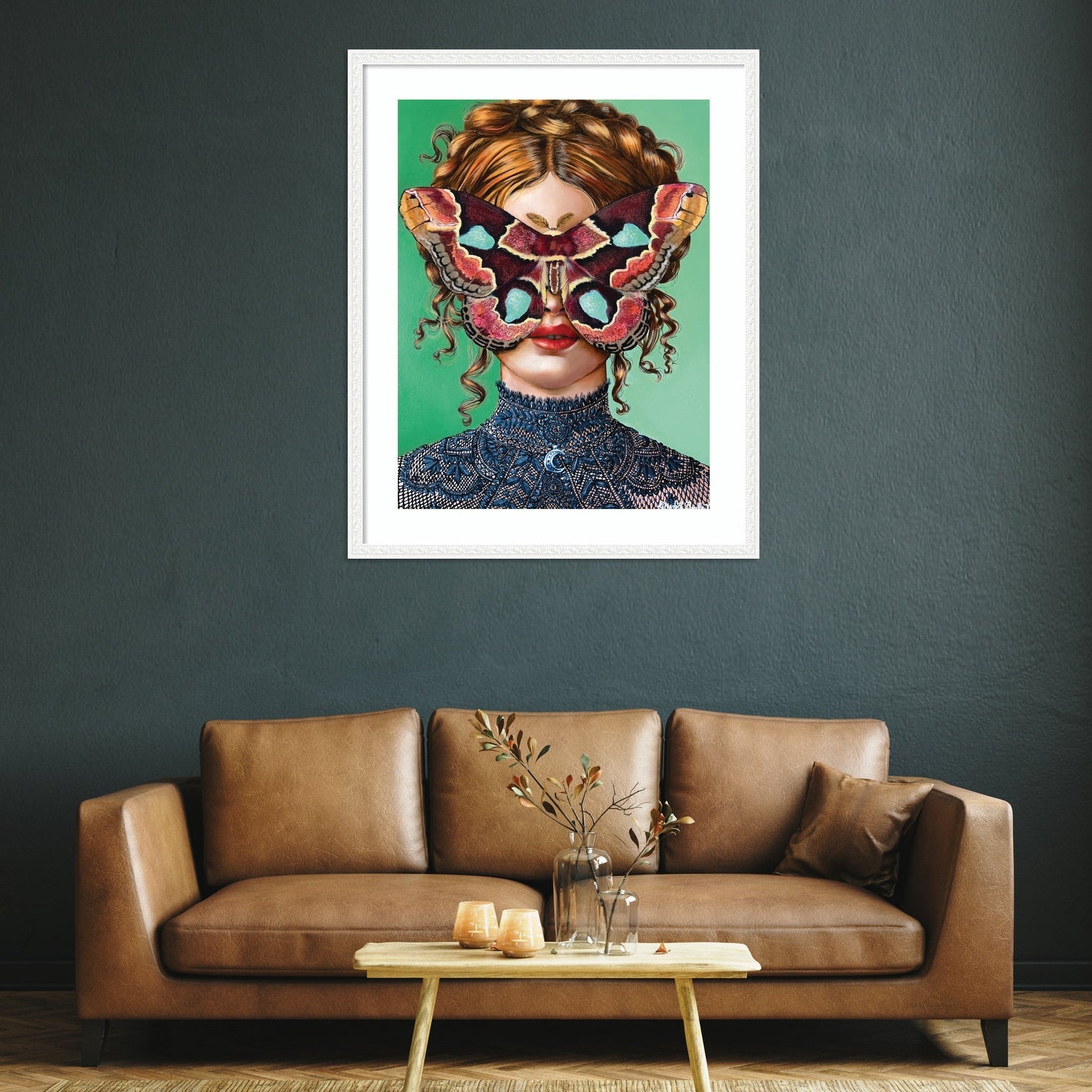 Framed artwork of a woman with a colorful mask above a brown sofa in a living room.