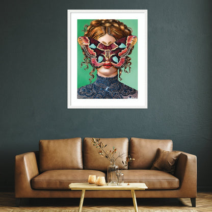 Framed artwork of a woman with a colorful mask above a brown sofa in a living room.