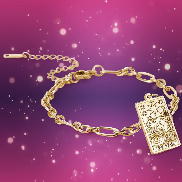 Gold bracelet with tarot card charm on a white background