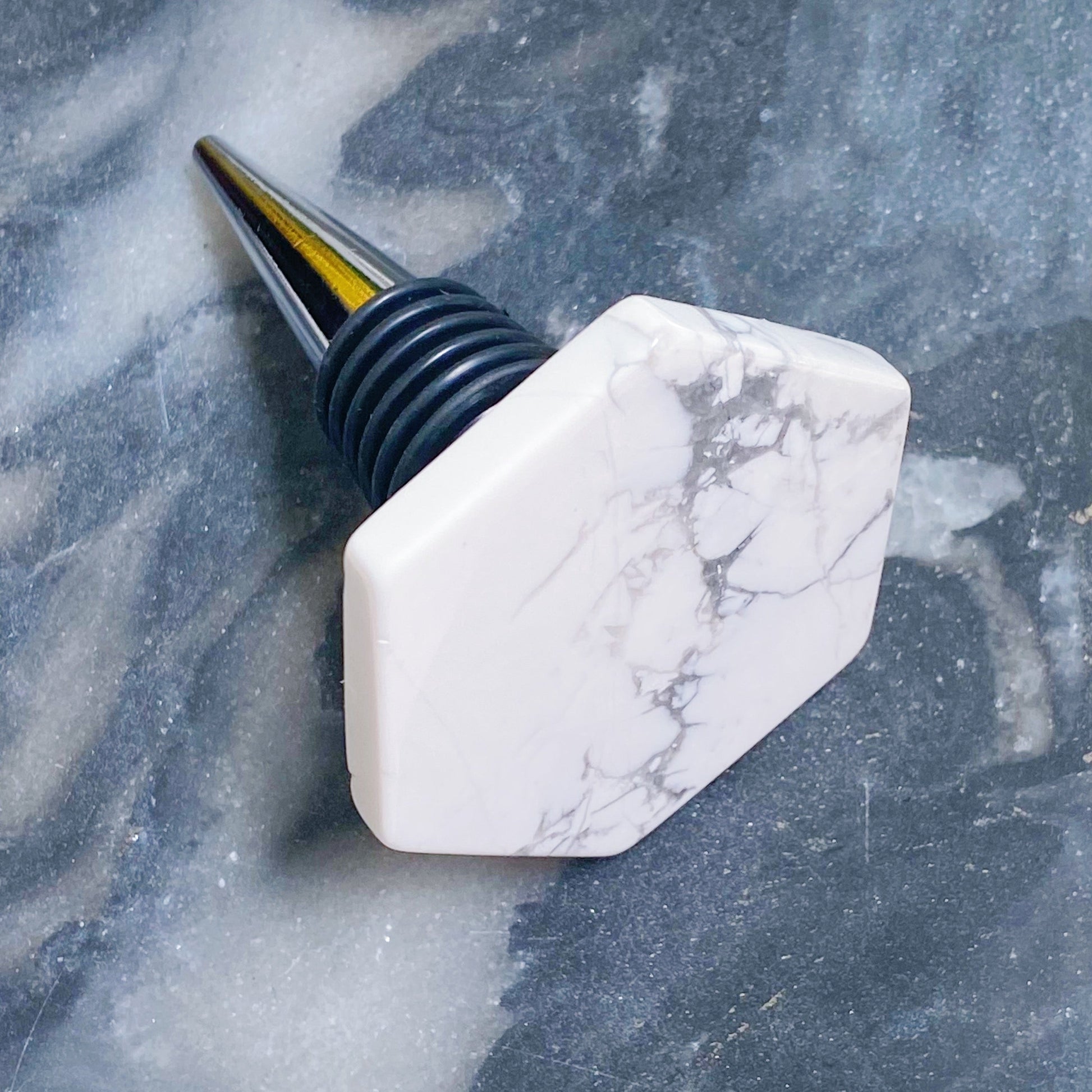 Marble-patterned bottle stopper on a textured gray surface