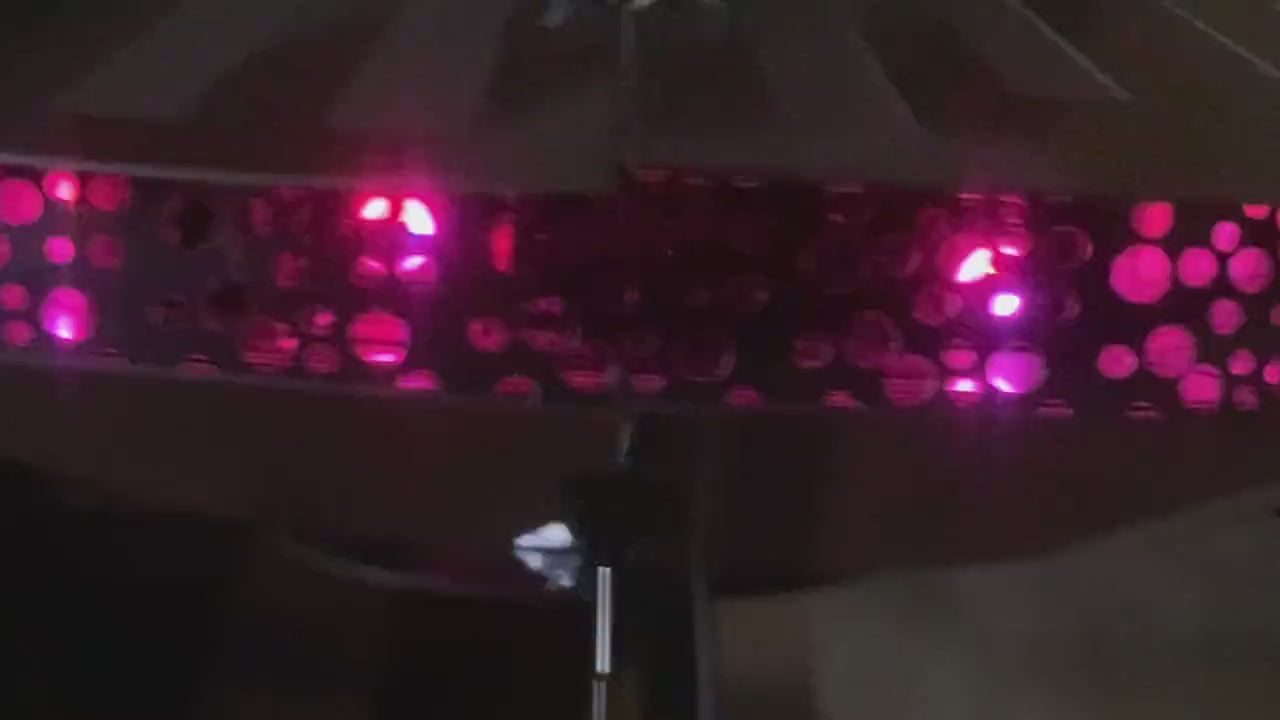 Close-up of a pink LED strip light on a dark background
