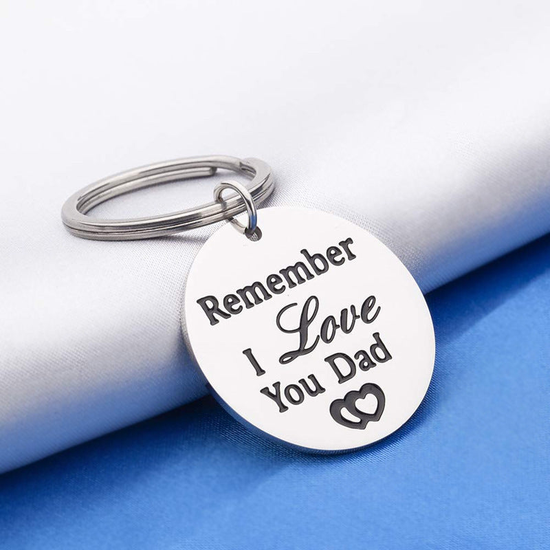 Silver keychain with 'Remember I Love You Dad' text on a white and blue background