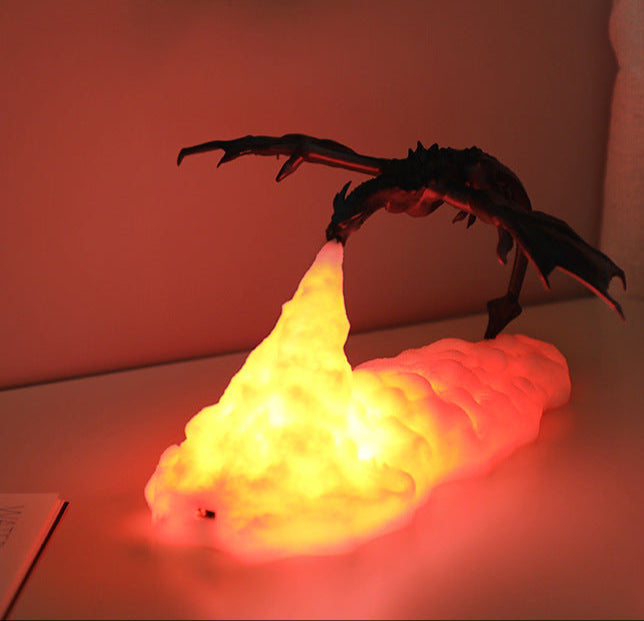 Decorative lamp shaped like a dragon with a glowing yellow base on a table.