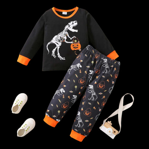 Children's Halloween-themed outfit with black long-sleeve shirt and pants on a wooden surface.
