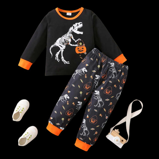 Children's Halloween-themed outfit with black long-sleeve shirt and pants on a wooden surface.