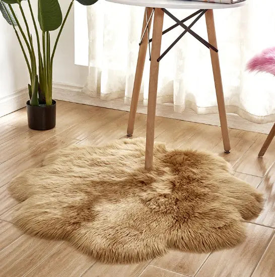 Fluffy brown rug on a wooden floor with a plant and chair in the background