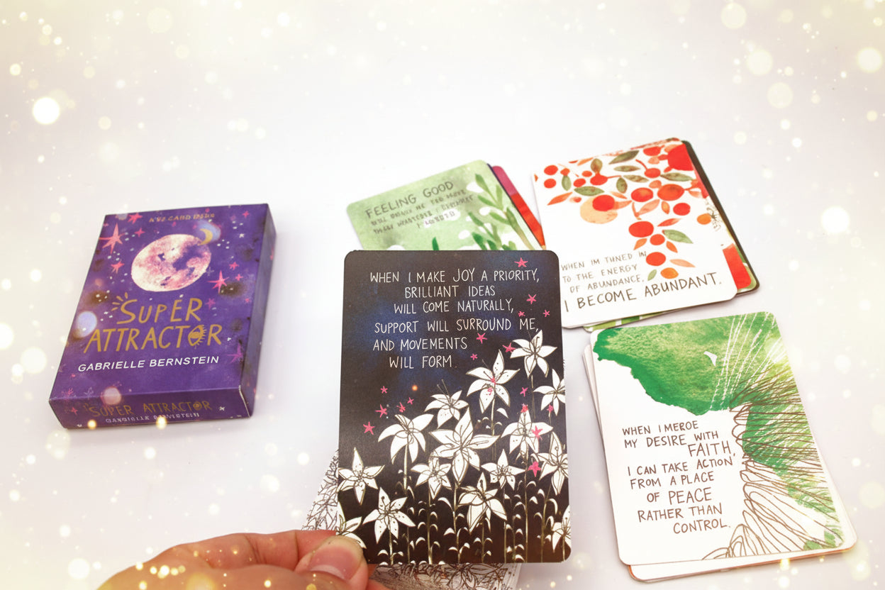 Super Attractor card deck with cards spread out on a white surface