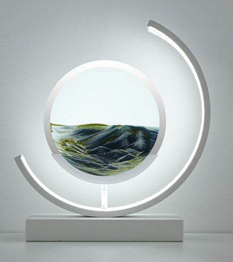 Modern decorative piece with circular design and landscape inside on a gray background