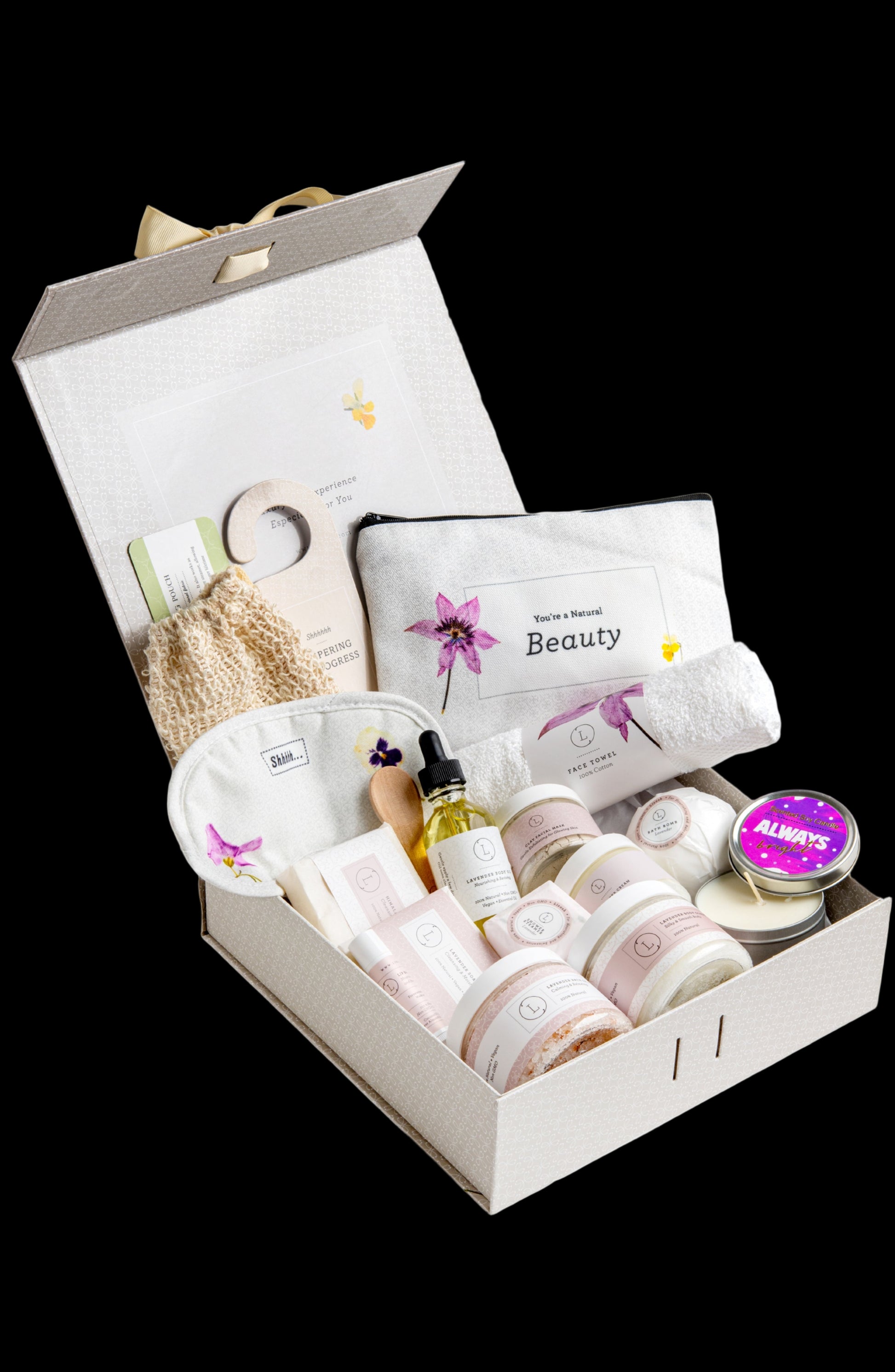 Open gift box containing beauty products on a white background