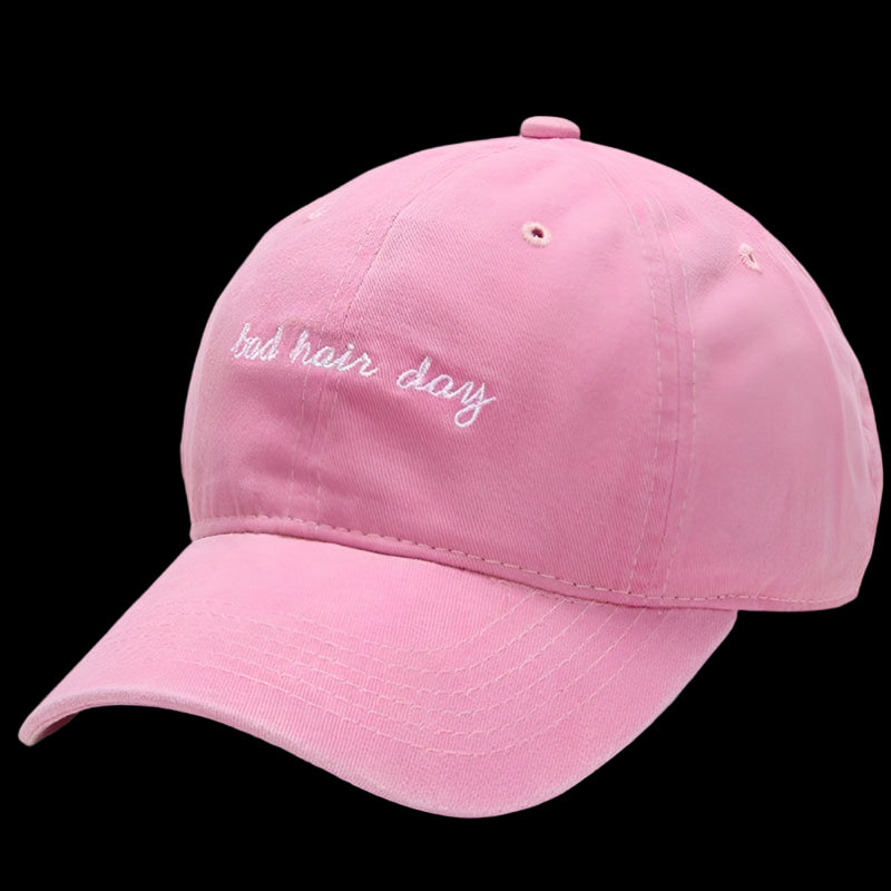 Pink baseball cap with 'bad hair day' text on a white background