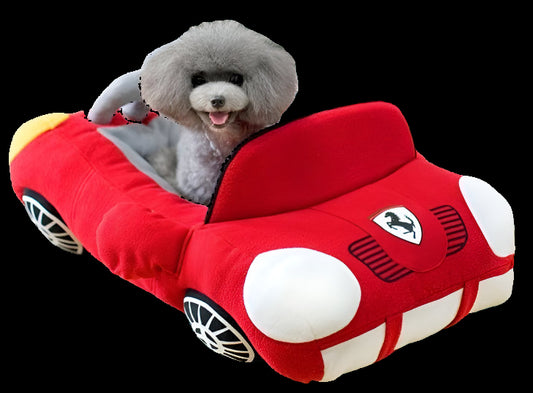 Red car-shaped pet bed with a dog inside, on a light wood floor.