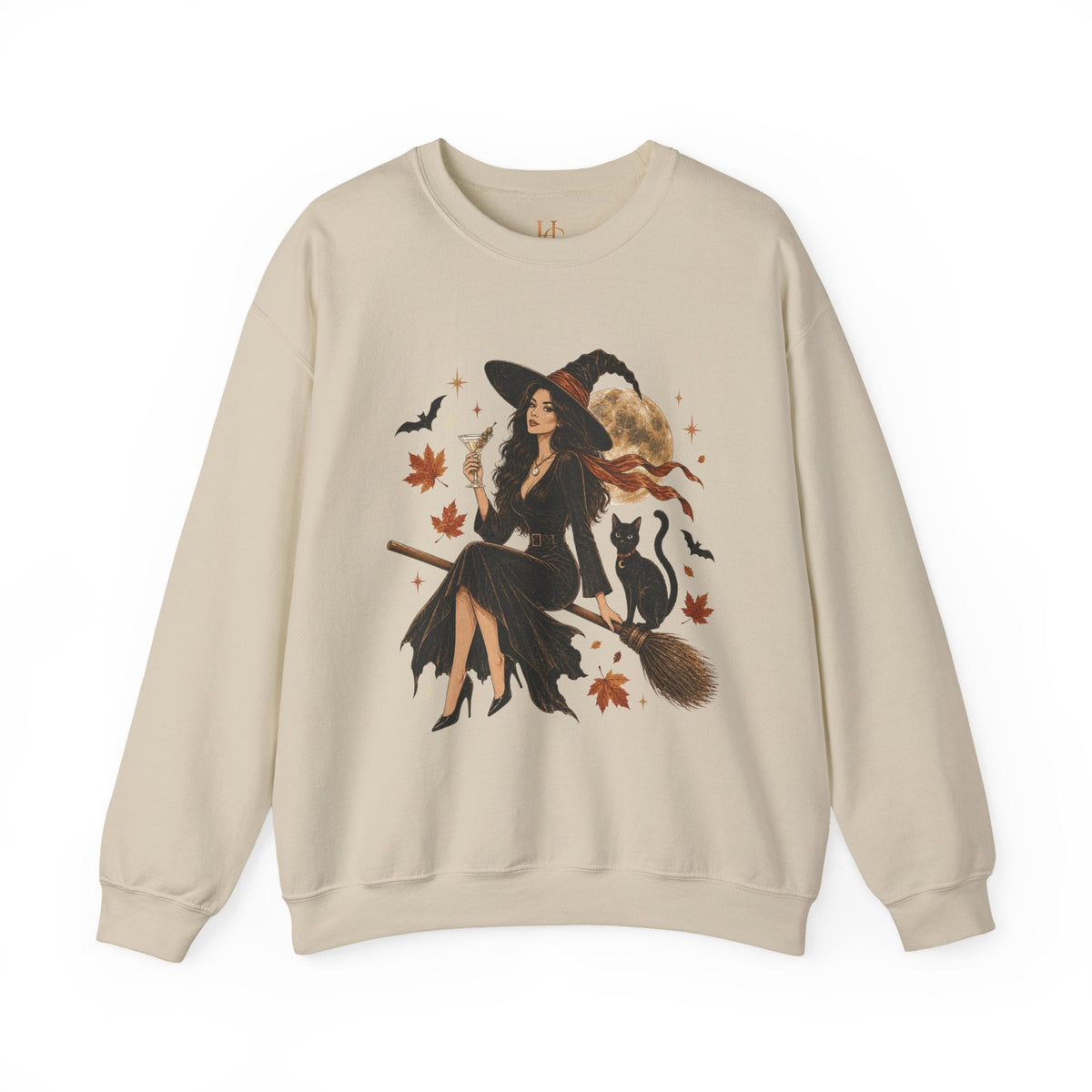 A beige crewneck sweatshirt featuring a large graphic print of a witch riding a broomstick with a black cat, surrounded by autumn leaves and bats.