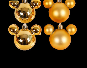 Gold spherical decorative item on a light pink background