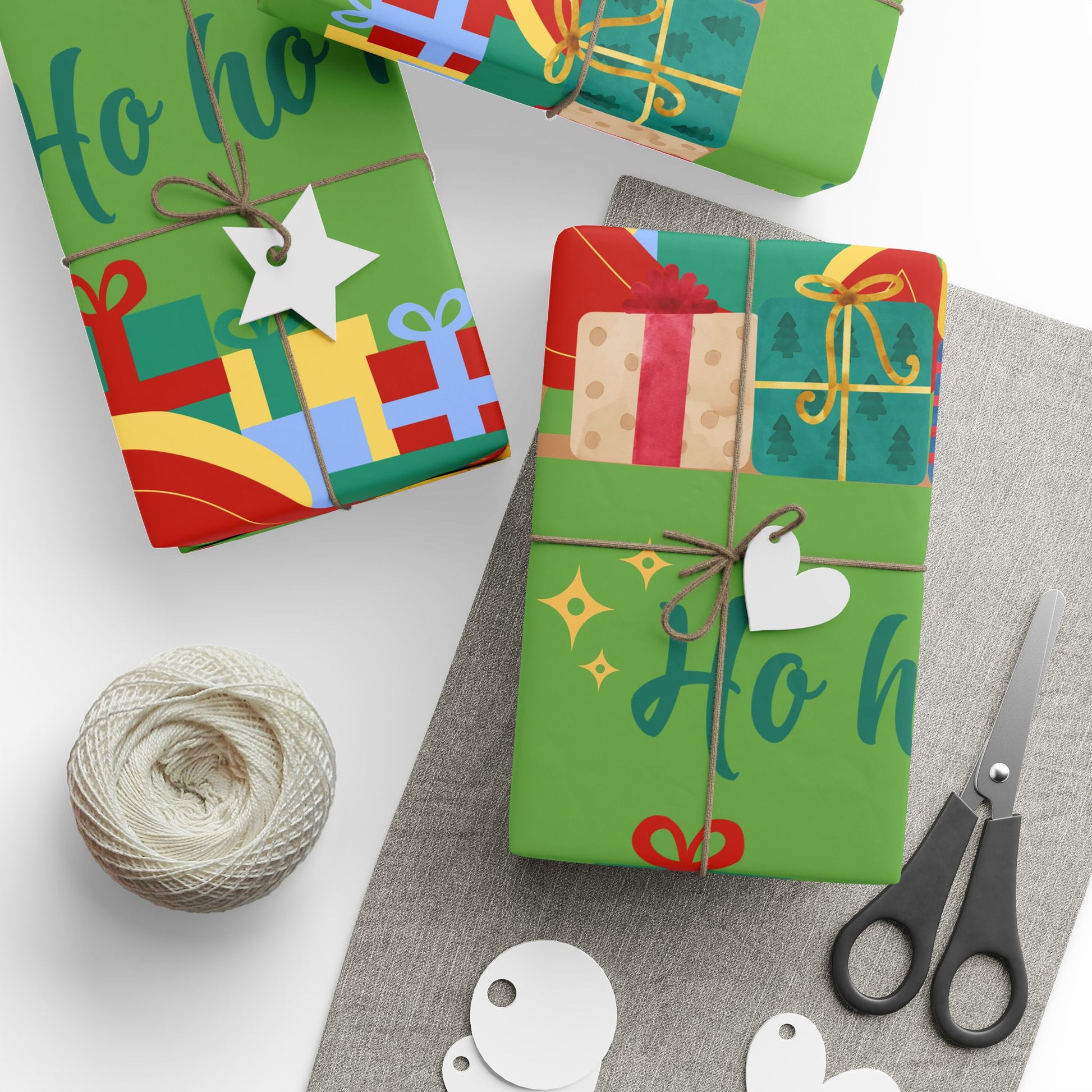 Colorful gift boxes with decorative ribbons, tags, and scissors on a white surface.