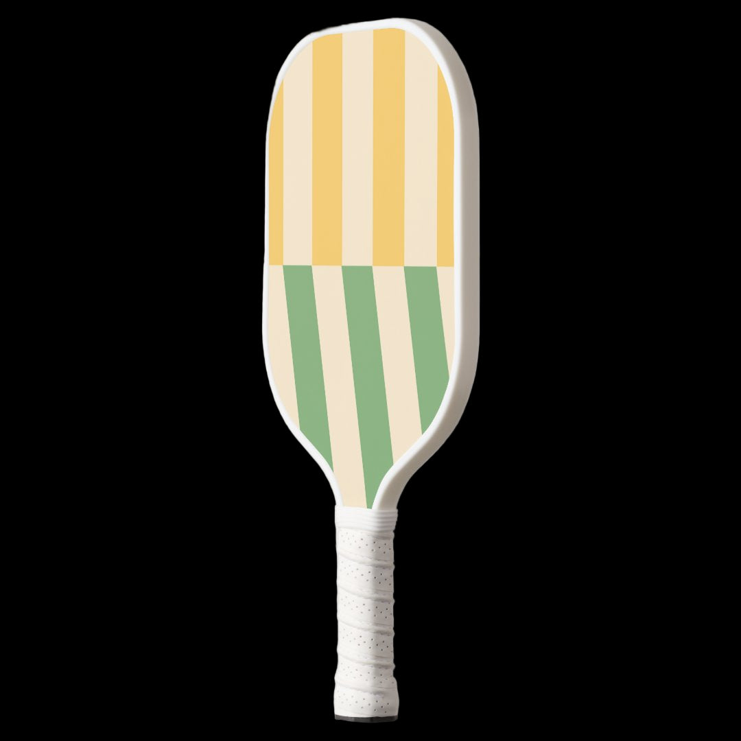 Striped paddle with yellow, green, and white colors on a light gray background