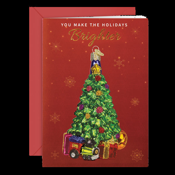 Christmas card with a decorated tree and train on a red background