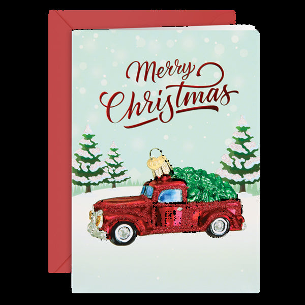 Christmas card with a red truck carrying a Christmas tree and 'Merry Christmas' text.