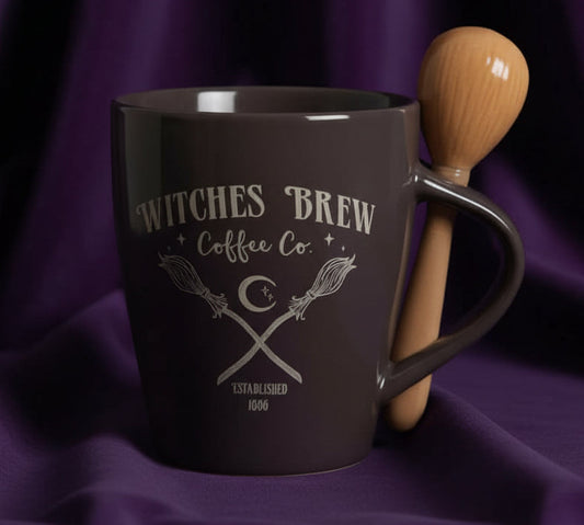 Brown mug with 'Witches Brew Coffee Co.' text and wooden spoon on a white background