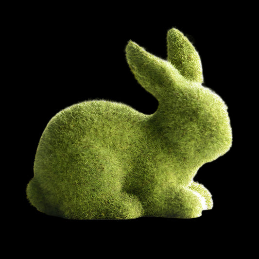 Green moss-like rabbit sculpture on a white surface