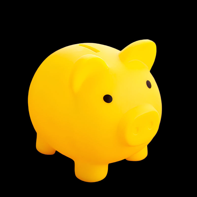 Yellow piggy bank on a pink surface with a blurred background